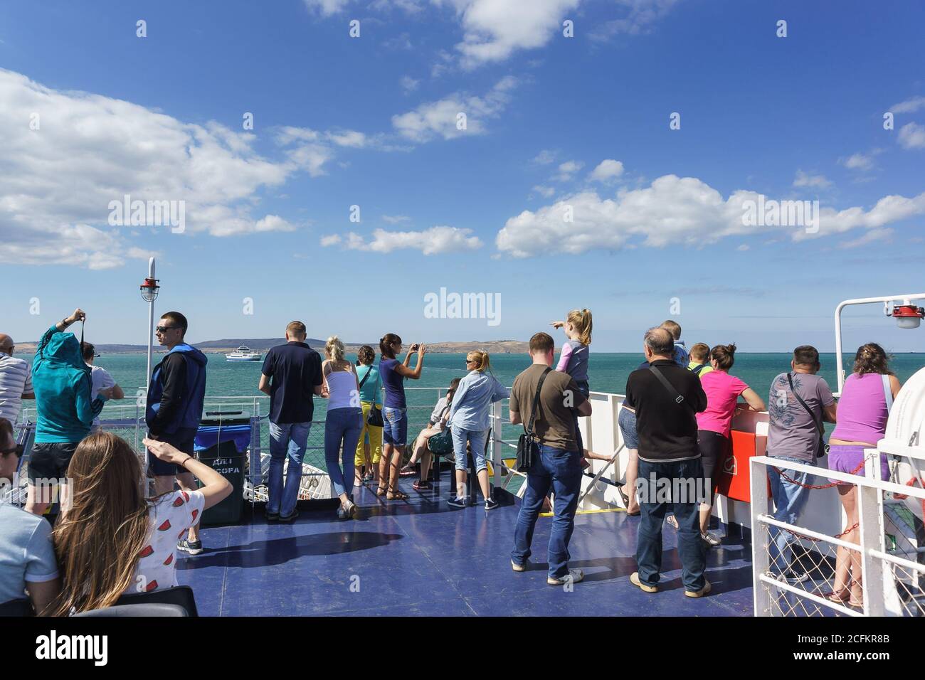 Russia, the Kerch Strait - September 02.2017: Passengers on the ferry 'Major Capiche' look at the Strait and the coast of the Crimean Peninsula Stock Photo