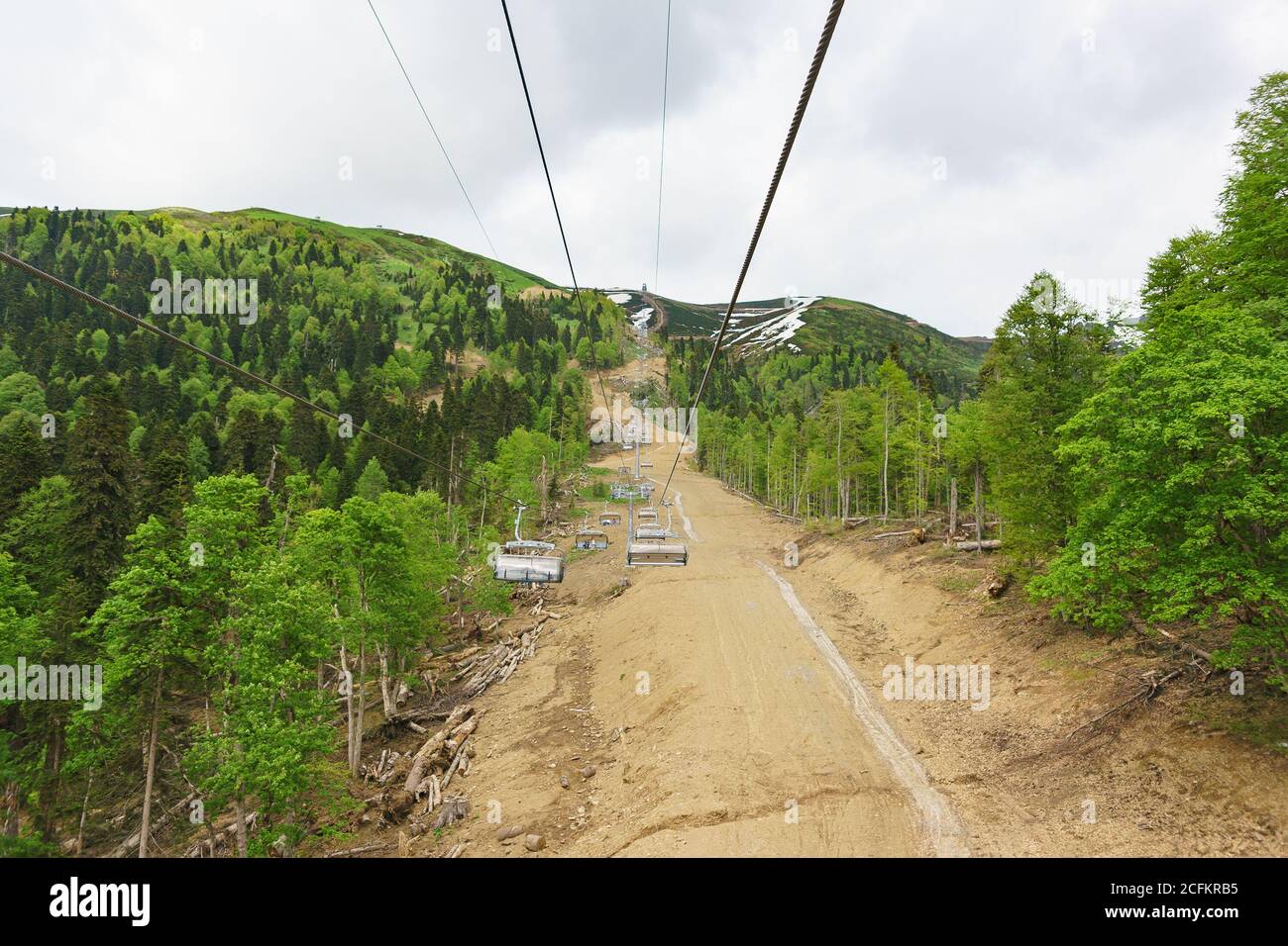 Estosadok, Sochi, Russia - June 10.2017: New chairlift the ski resort 'Rosa Khutor' in the Caucasus mountains. On the slope lie the remains of felled Stock Photo