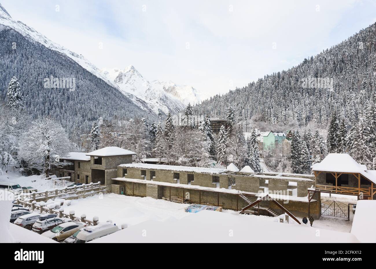 Dombay, Karachay-Cherkess Republic, Russia-December 15, 2018: courtyard of the Dombay hotel complex in winter. Along the fence is the construction of Stock Photo