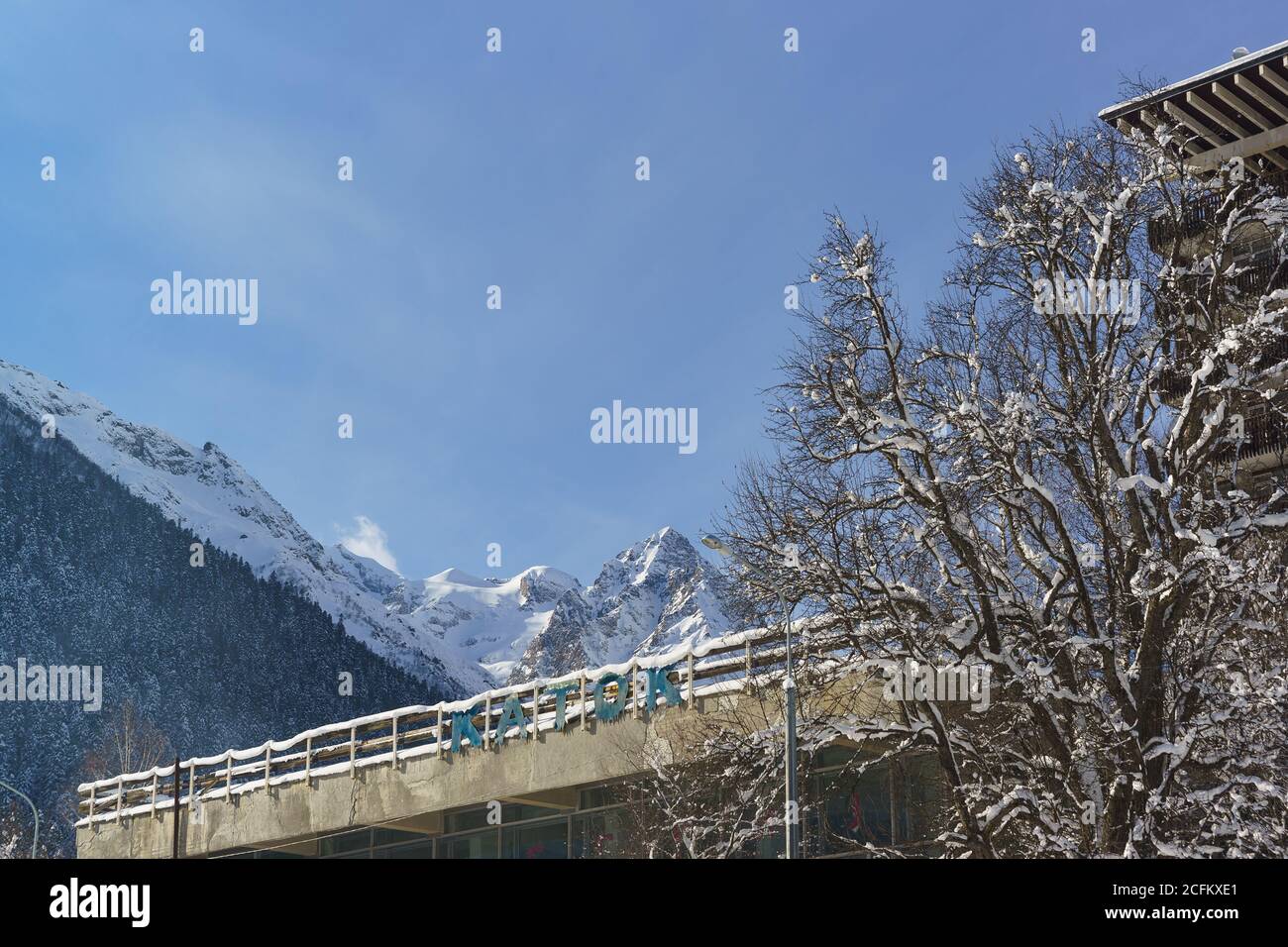 Dombai, Karachay-Cherkess Republic, Russia-December 16, 2018: Dilapidated inscription in Russian skating RINK on the background of mountain peaks. Res Stock Photo