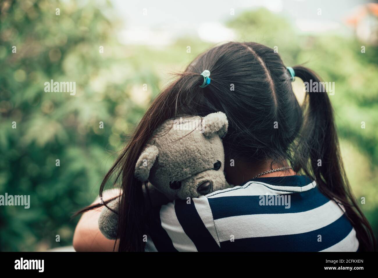 Asian lovely child girl hug teddy bear with love Stock Photo