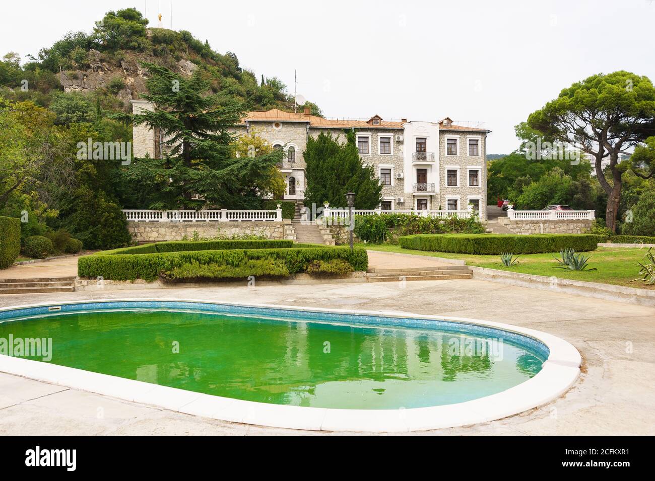 Koreiz, Yalta, Crimea, Russia - September 13, 2018: Golitsyn Palace building, trimmed shrubs and decorative pool on the territory of the estate of the Stock Photo