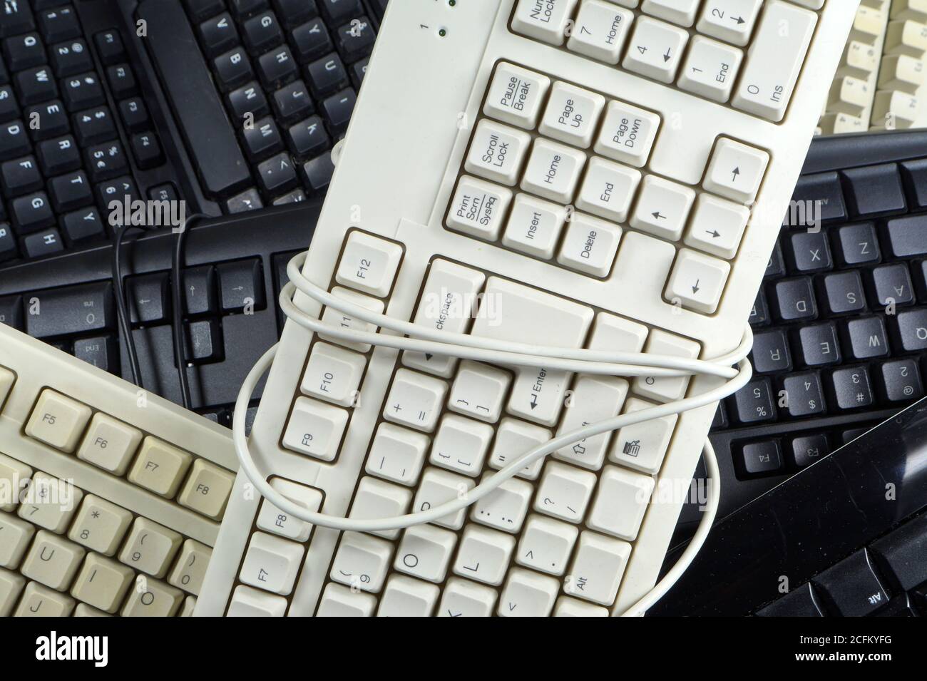 The problem of consumer electronics waste. Worn computer keyboards. Stock Photo