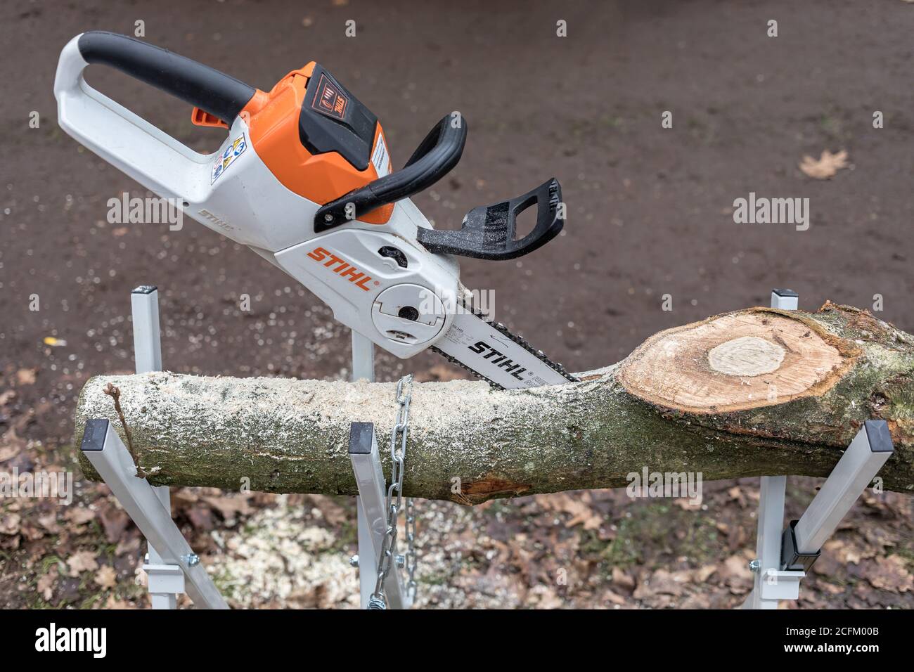 electric chainsaw in a branch Stock Photo