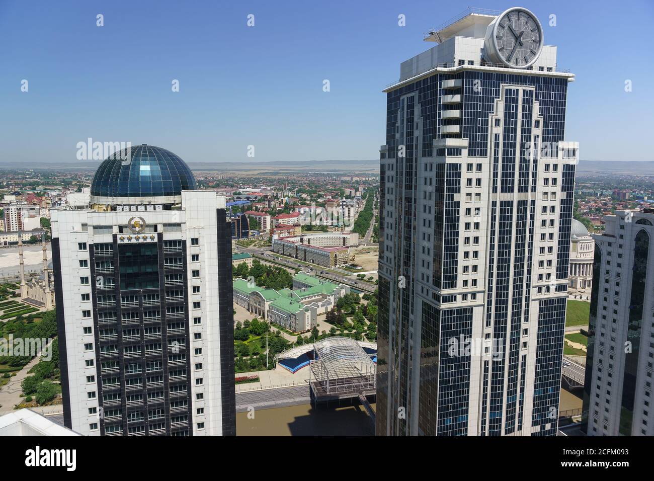 Grozny, Chechen Republic, Russia - June 02, 2019: Olympus Tower with the largest clock in the world and Grozny city hotel in the city center Stock Photo