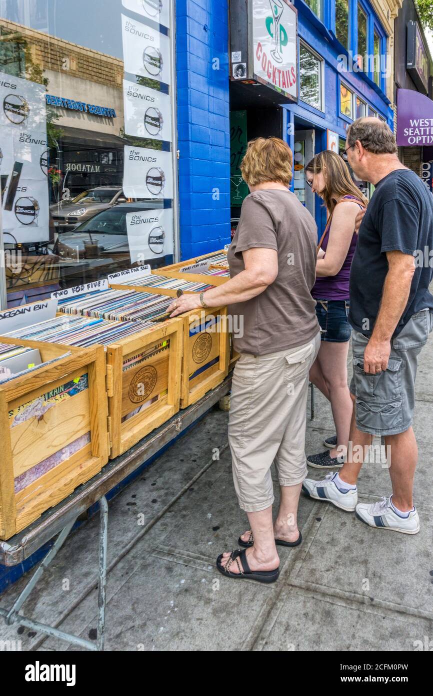 People looking in the bargain bin of vinyl records outside Easy Street Records in West Seattle. Stock Photo