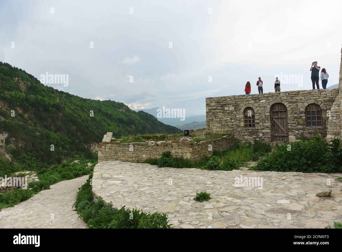 Hoi, Vedensky district, Chechen Republic, Russia - June 01.2019: Tourists visiting the ancient settlement of the guards. Cloudy day in the Caucasus mo Stock Photo