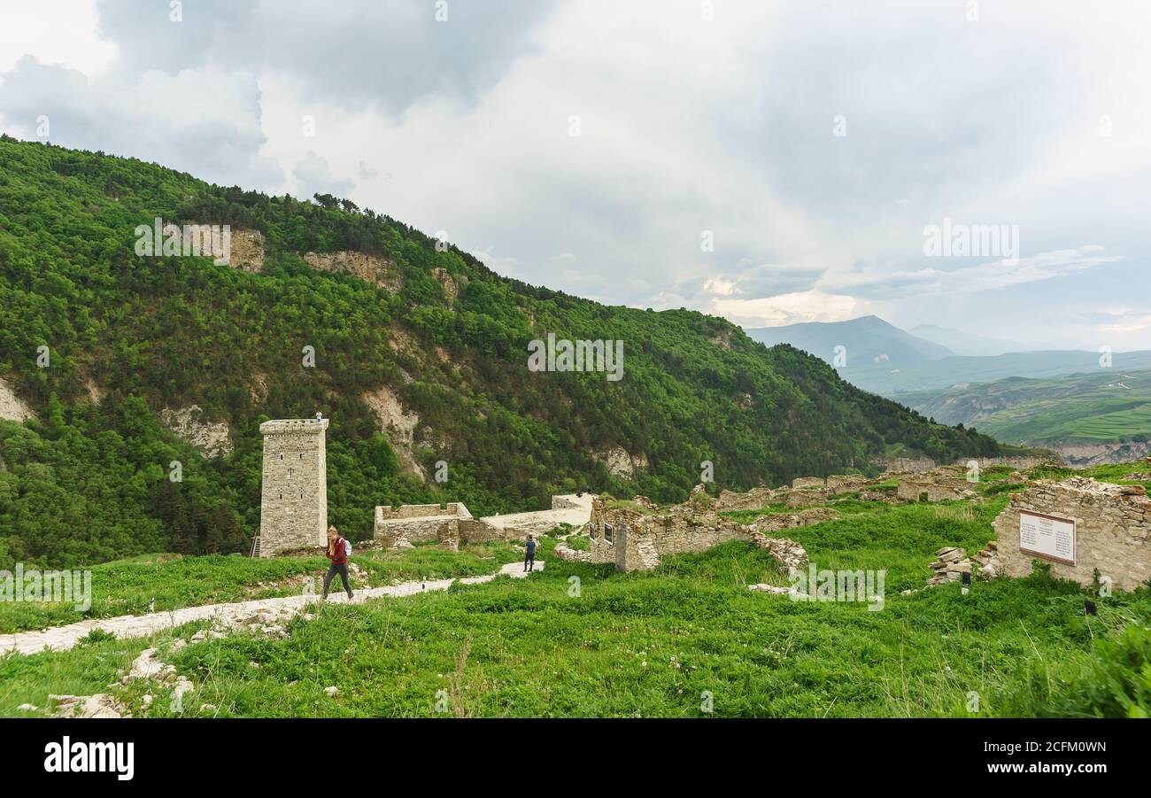 Hoi, Vedensky district, Chechen Republic, Russia - June 01.2019: Tourists in the ancient settlement of the guards. Cloudy day in the Caucasus mountain Stock Photo