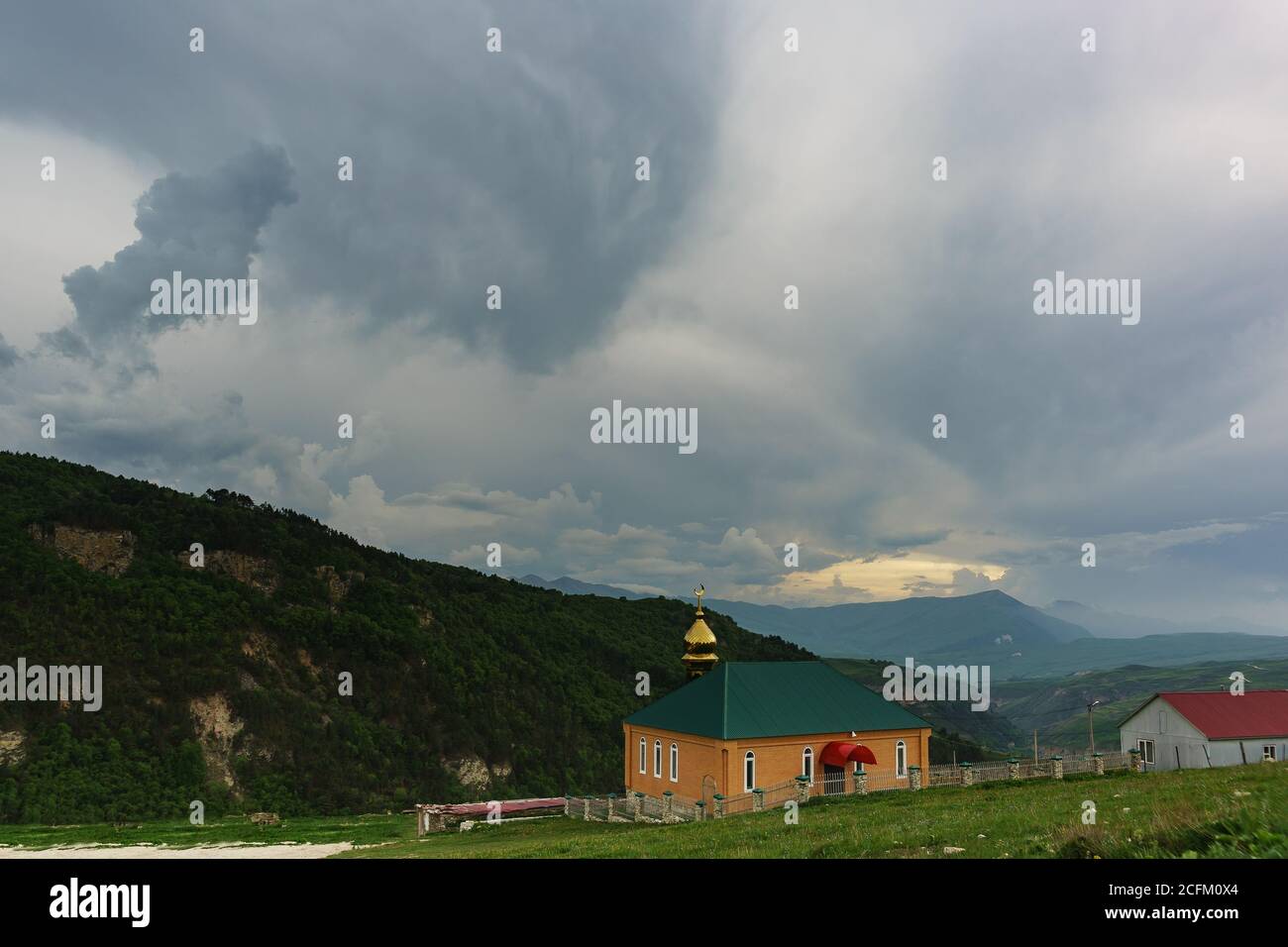 Hoi, Vedeno district, Chechen Republic, Russia - June 01.2019: New modern mosque in reviving the settlements guards. Cloudy day in the Caucasus mounta Stock Photo