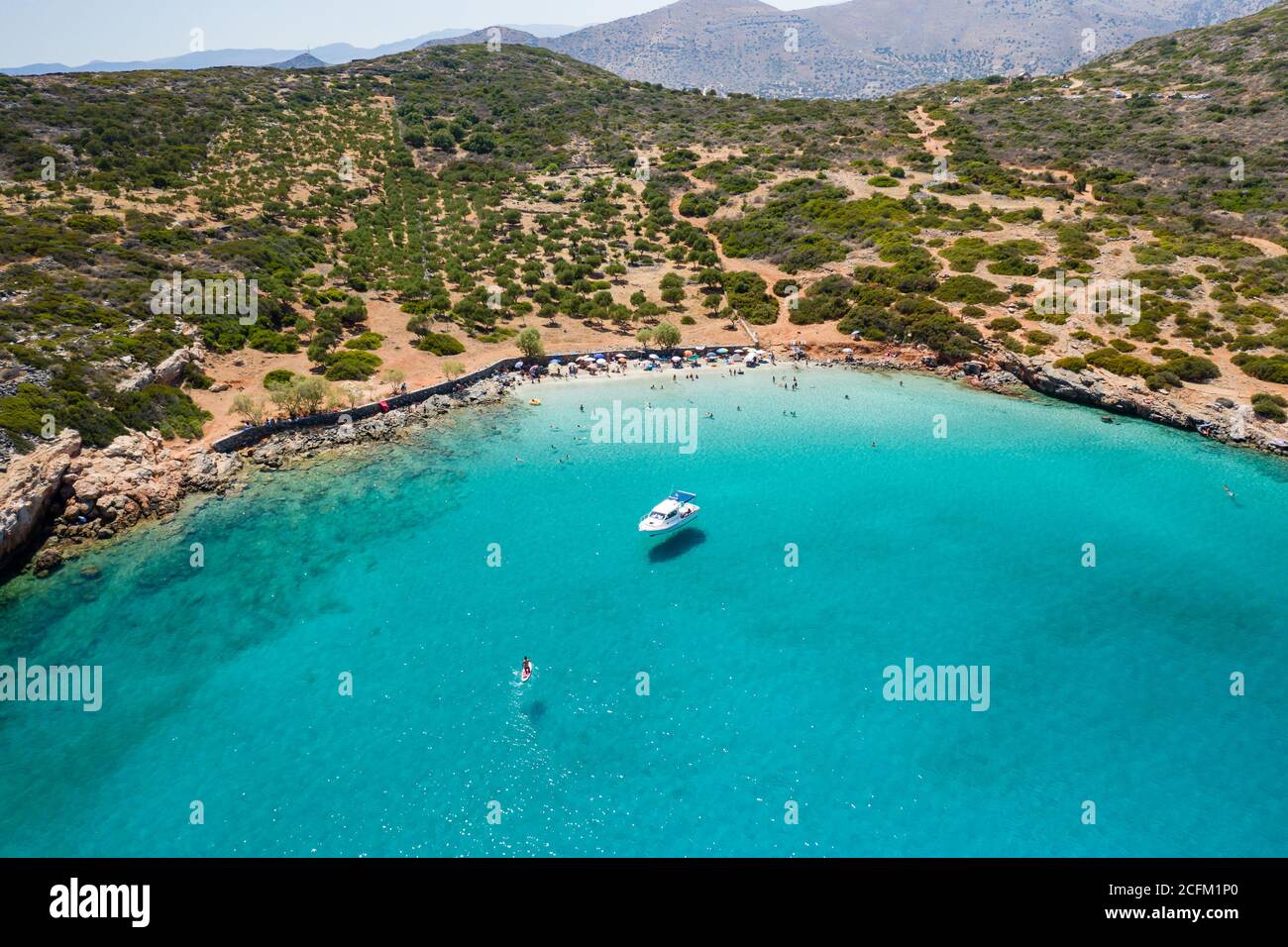 Aerial drone view of a small beach on a rocky, barren coastline and