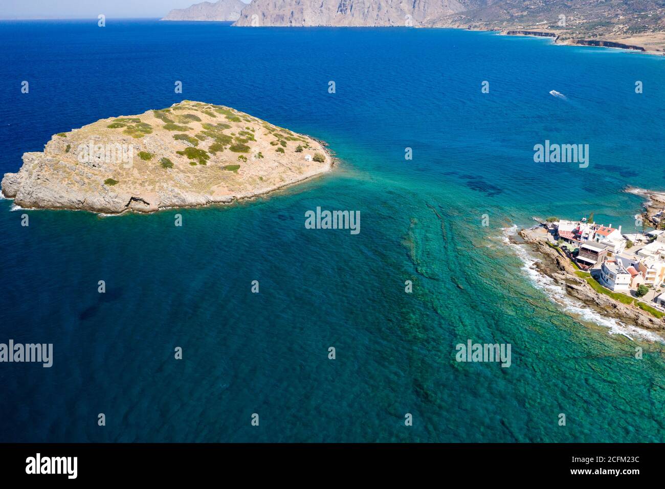 Aerial drone view of the tiny village of Mochlos and offshore island with ancient ruins (Crete, Greece) Stock Photo