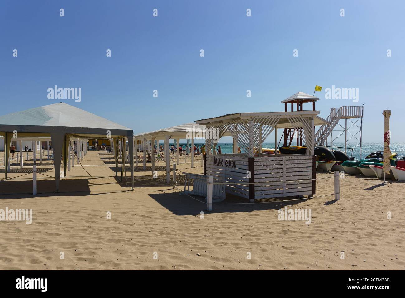 Yevpatria, Crimea, Russia-September 12, 2019: Shadow visits on the sandy beach 'Novy' in the resort town. Russian text ' Massage' Stock Photo