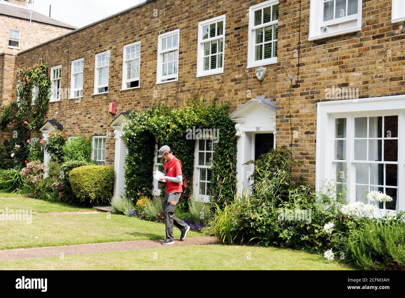 Postman delivering letters to styled house in St Mary's