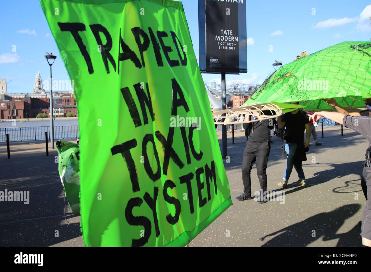 London, UK. 06th Sep, 2020. Extinction Rebellion protestors march from Parliament Square to Tate Modern to highlight the dangers to marine life from global warming and climate change, 6th September 2020. A giant sea turtle with a banner saying trapped in a toxic system Credit: Denise Laura Baker/Alamy Live News Stock Photo