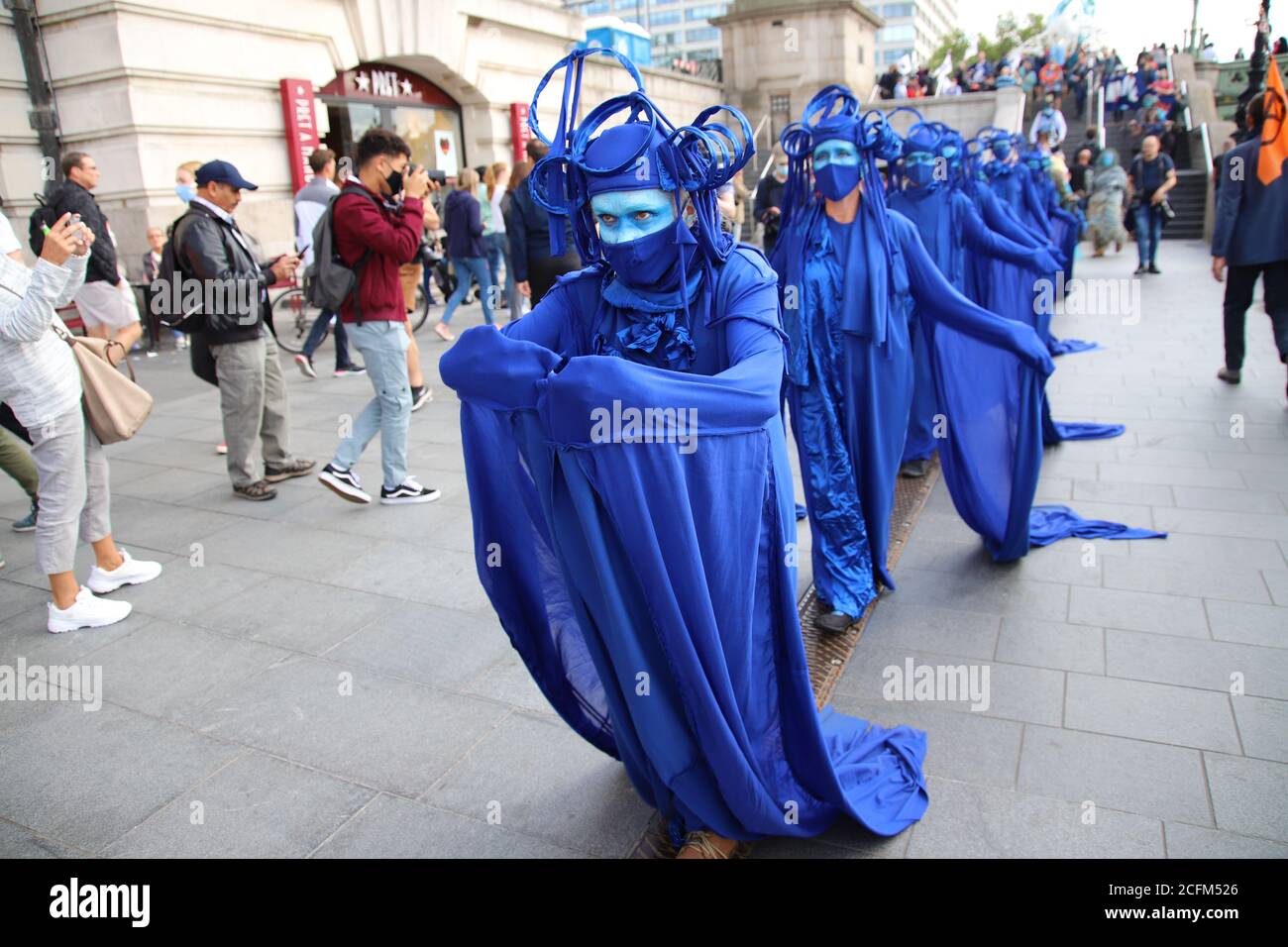 London, UK. 06th Sep, 2020. Extinction Rebellion protestors march from Parliament Square to Tate Modern to highlight the dangers to marine life from global warming and climate change, 6th September 2020. Protestors dressed in blue referred to as 'the wave' move in wave formation through the streets Credit: Denise Laura Baker/Alamy Live News Stock Photo