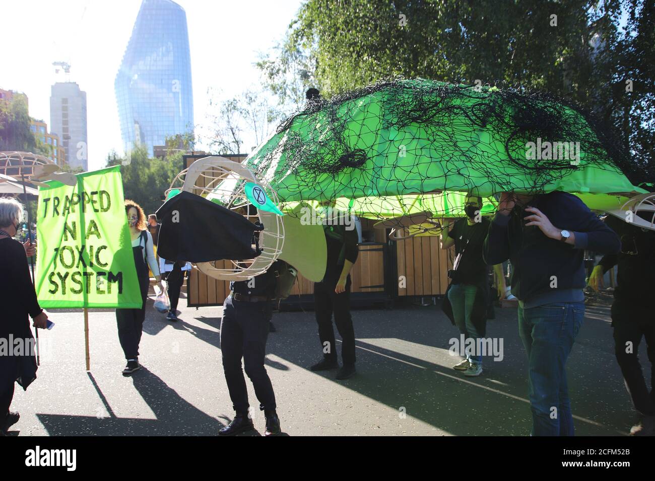 London, UK. 06th Sep, 2020. Extinction Rebellion protestors march from Parliament Square to Tate Modern to highlight the dangers to marine life from global warming and climate change, 6th September 2020. A giant sea turtle is carried by protestors with a banner saying trapped in a toxic system Credit: Denise Laura Baker/Alamy Live News Stock Photo