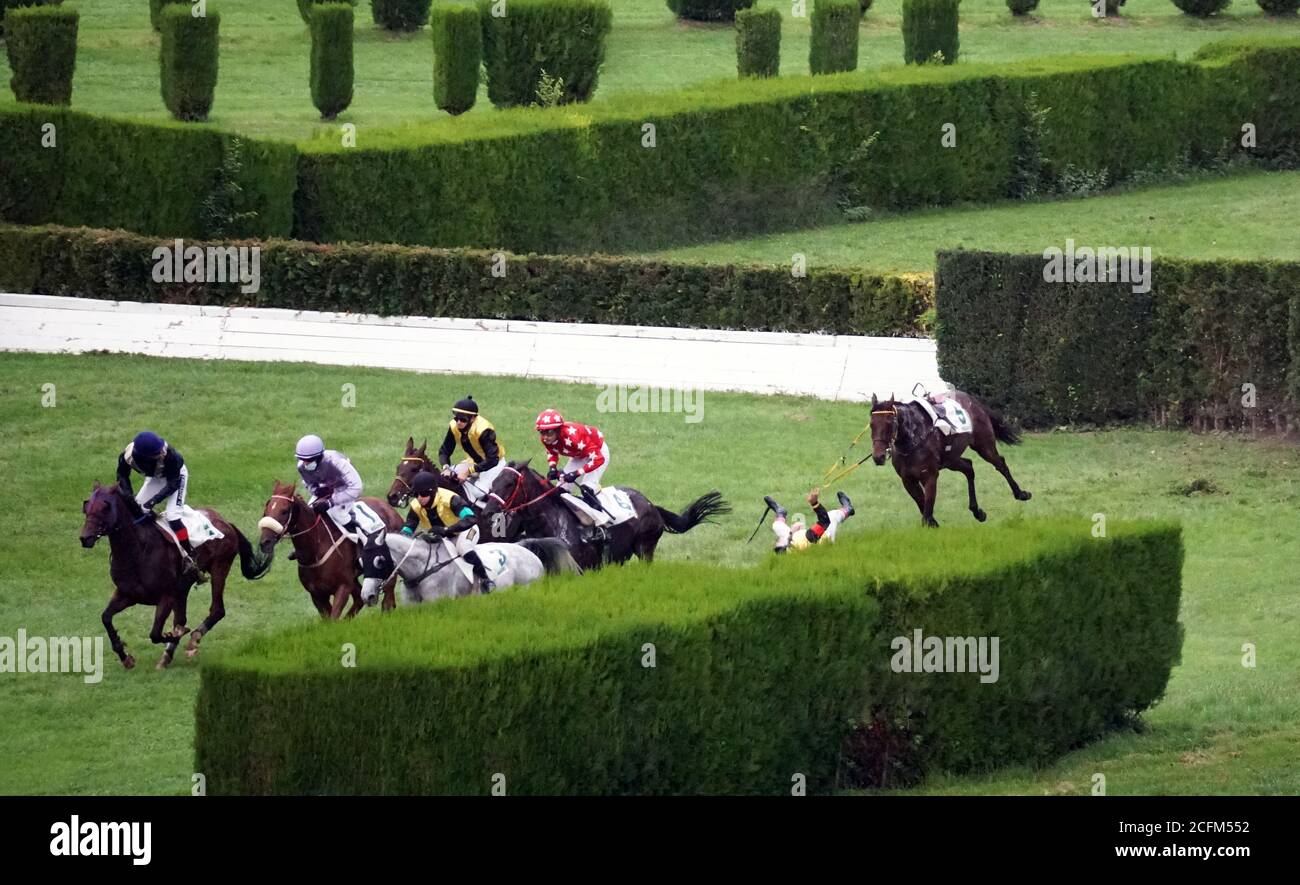 A jockey falling from a horse at the race while others running further at the race in Merano, Italy on Sept. 6th of 2020. Stock Photo