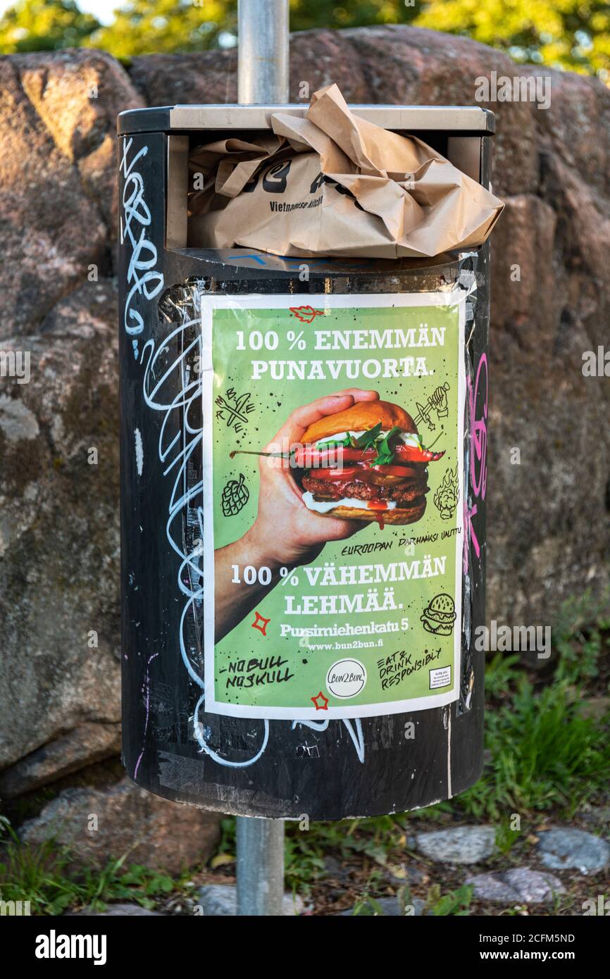 Public trash can with advertising poster in Helsinki, Finland Stock Photo