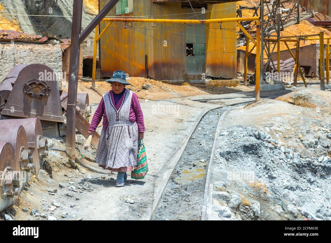 Indigenous woman at work in the silver mine of Potosi in the ancient tin factory, Bolivia. Stock Photo