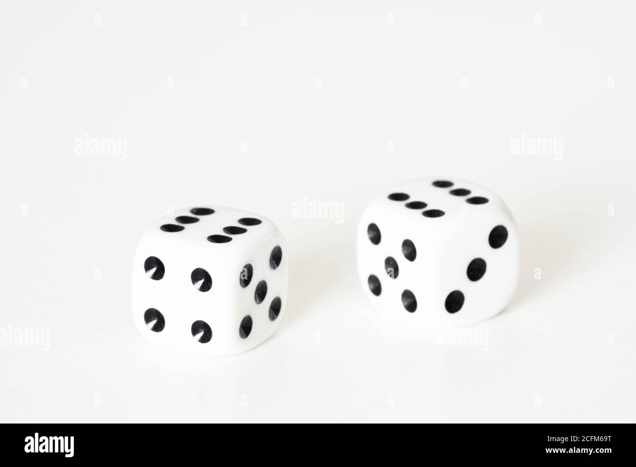 Traditional dice or die against white background. Luck, lucky, roll of the dice, luck of the draw, take a chance, Stock Photo