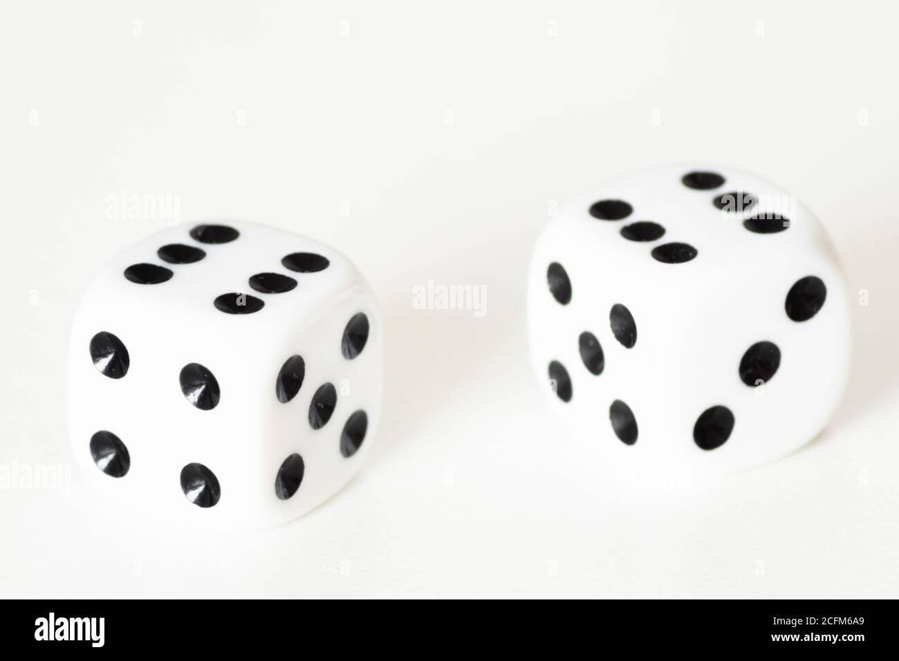 Traditional dice or die against white background. Luck, lucky, roll of the dice, luck of the draw, take a chance, Stock Photo
