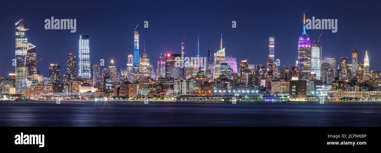 New York CIty panoramic cityscape of Midtown West skyscrapers at night along Hudson River Park. Manhattan, NY, USA Stock Photo