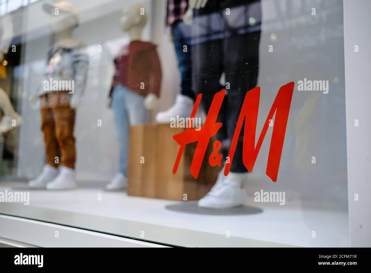 Stafford / UK - September 5 2020: H&M logo seen on a shop window with a  blurred manequeens of children on the background. Selective focus Stock  Photo - Alamy