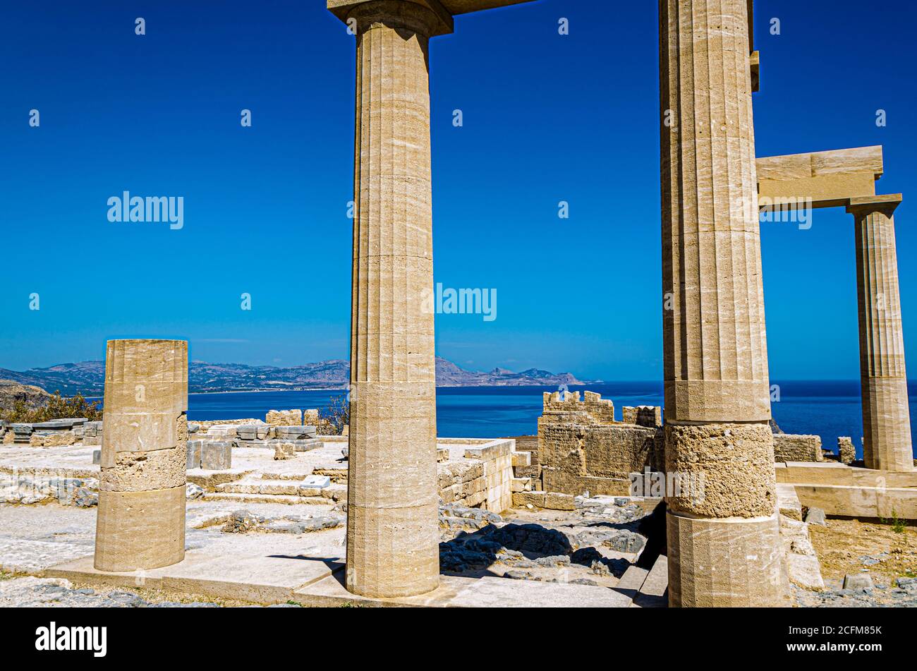 Ruins of the acropolis of the city of Lindos on the island of Rhodes and the Aegean Sea in the background. Greece Stock Photo