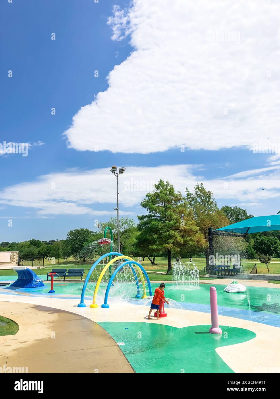 Modern splash park with shaded picnic areas for summertime activities