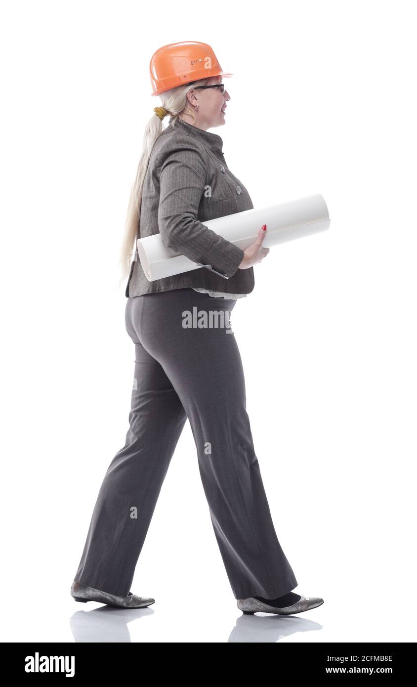 female architect with a roll of drawings striding towards you Stock Photo