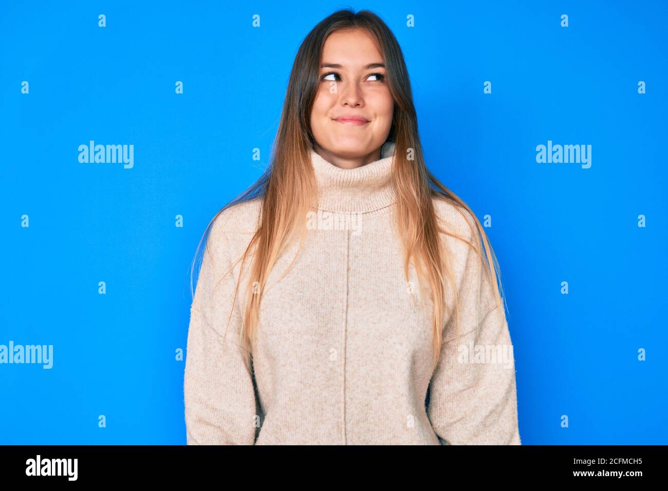 Beautiful caucasian woman wearing wool winter sweater smiling looking ...