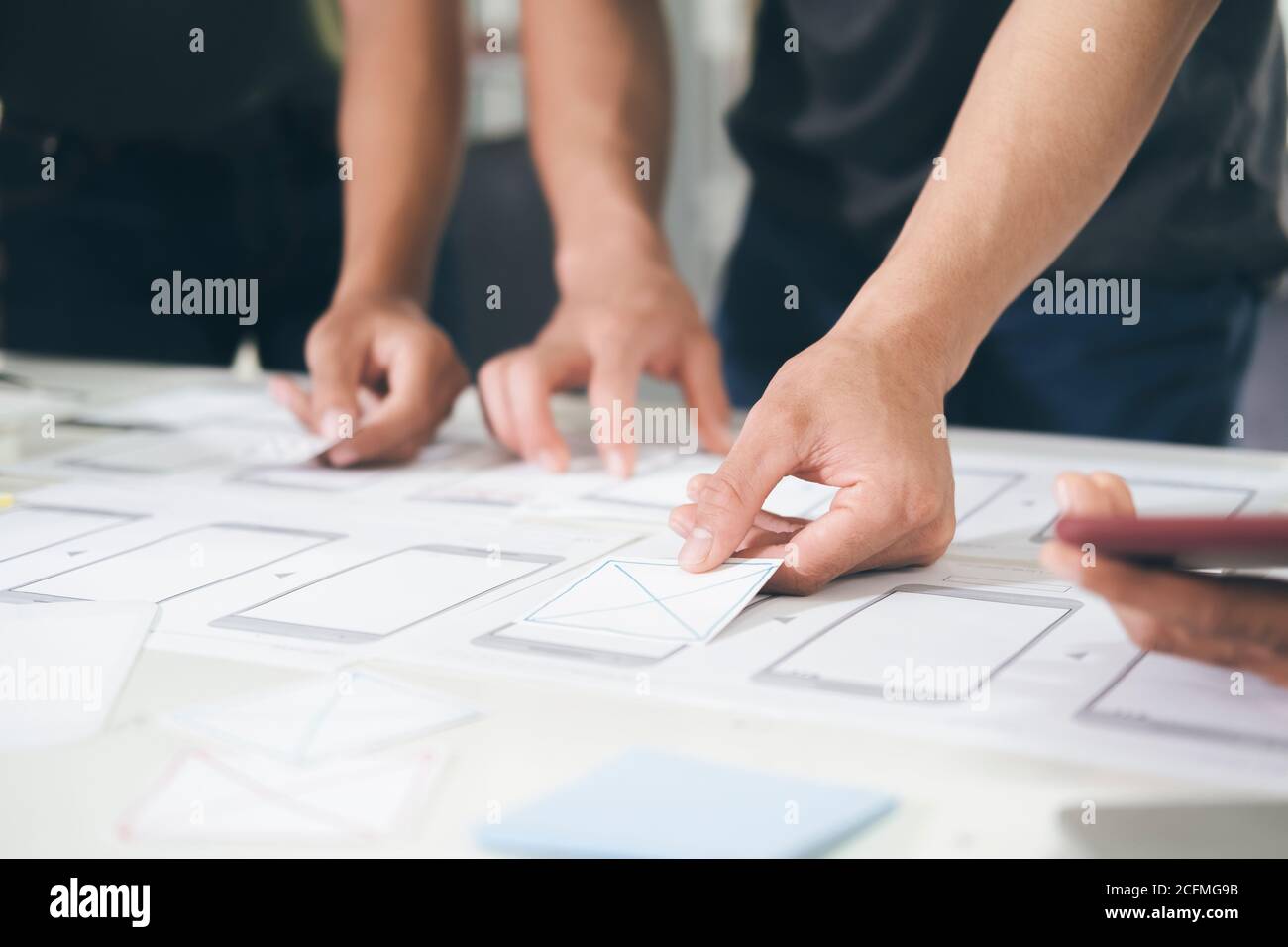 Programmer and UX UI designer working in a software development and coding technologies. Mobile and website design and programing development technolo Stock Photo