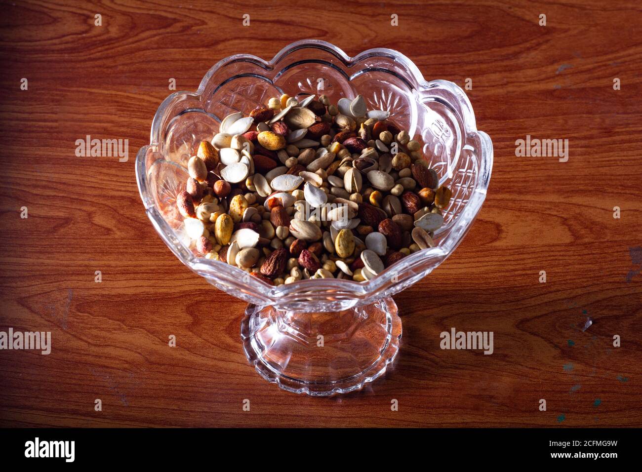 A dry fruits bowl on a table Stock Photo