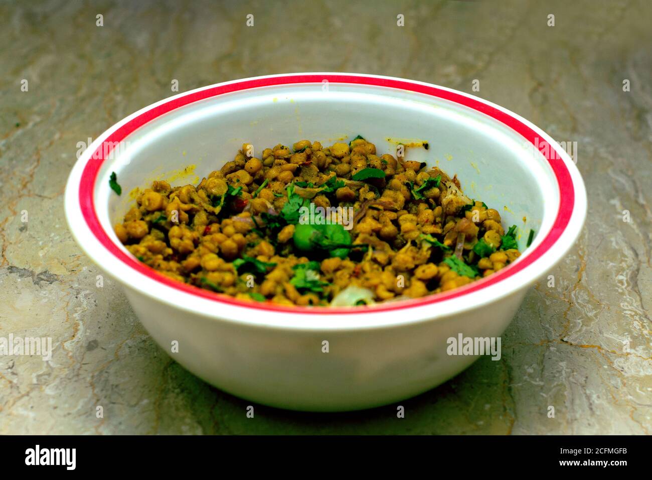 Spicy yellow peas with green chilly Stock Photo