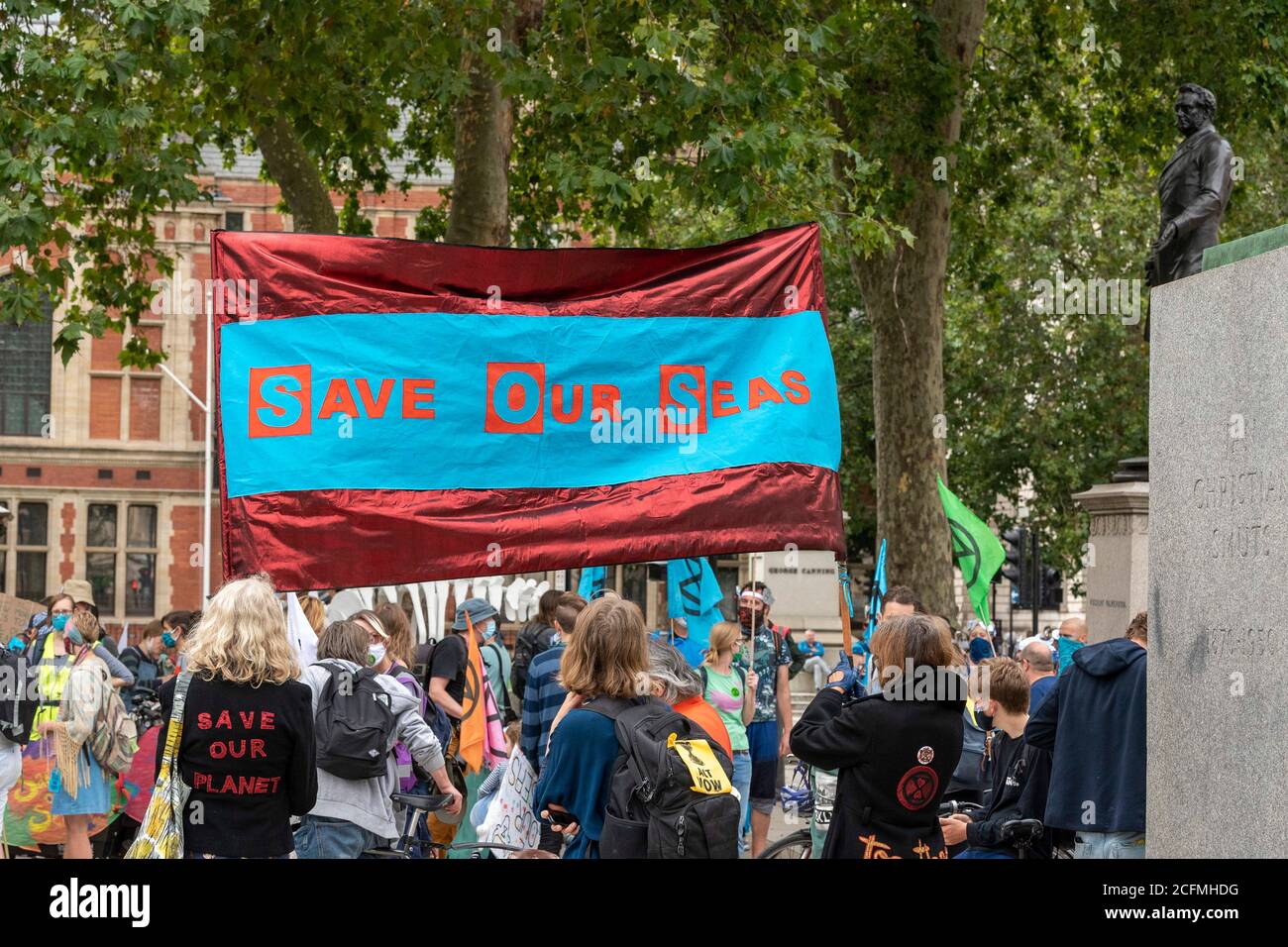 Protesters hold a banner saying save our seas during the demonstration.The groups of Extinction Rebellion Marine, Ocean Rebellion, Sea Life Extinction and Animal Rebellion marched in London in a ‘socially distanced grief march’ to demand protection for the oceans and in protest against global governmental inaction to save the seas due to climate breakdown and human interference, and the loss of lives, homes and livelihoods from rising sea levels. Stock Photo
