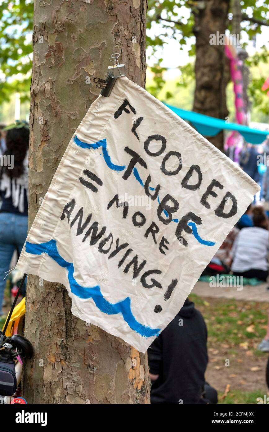 Climate change banner seen during the Extinction Rebellion Macabre Beach Party.A beach party (on grass) next to the River Thames was held by the Extinction Rebellion Marine supporters to highlight the dangers of the extreme weather caused by climate change and sound an alarm for the urgent need to take action now to avert catastrophic flooding in London, the UK and the whole world. Stock Photo