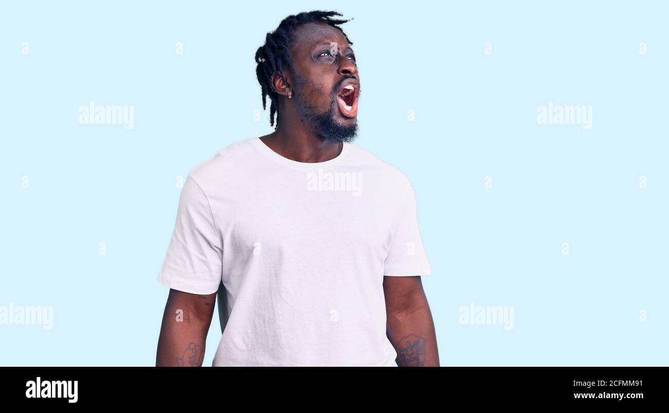 Young african american man with braids wearing casual white tshirt ...