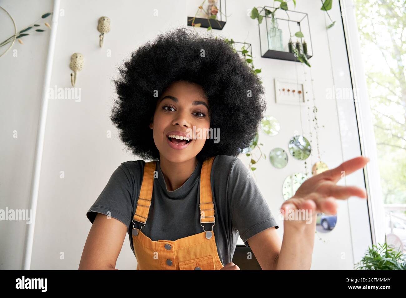 African hipster young woman looking at webcam talking to camera, headshot. Stock Photo