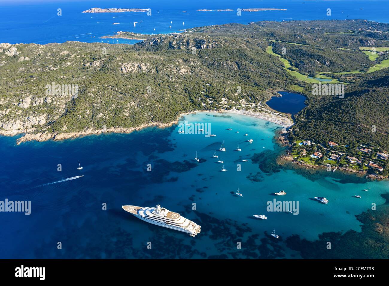 View from above, stunning aerial view of the Grande Pevero beach with boats and luxury yachts sailing on a turquoise, clear water. Sardinia, Italy. Stock Photo