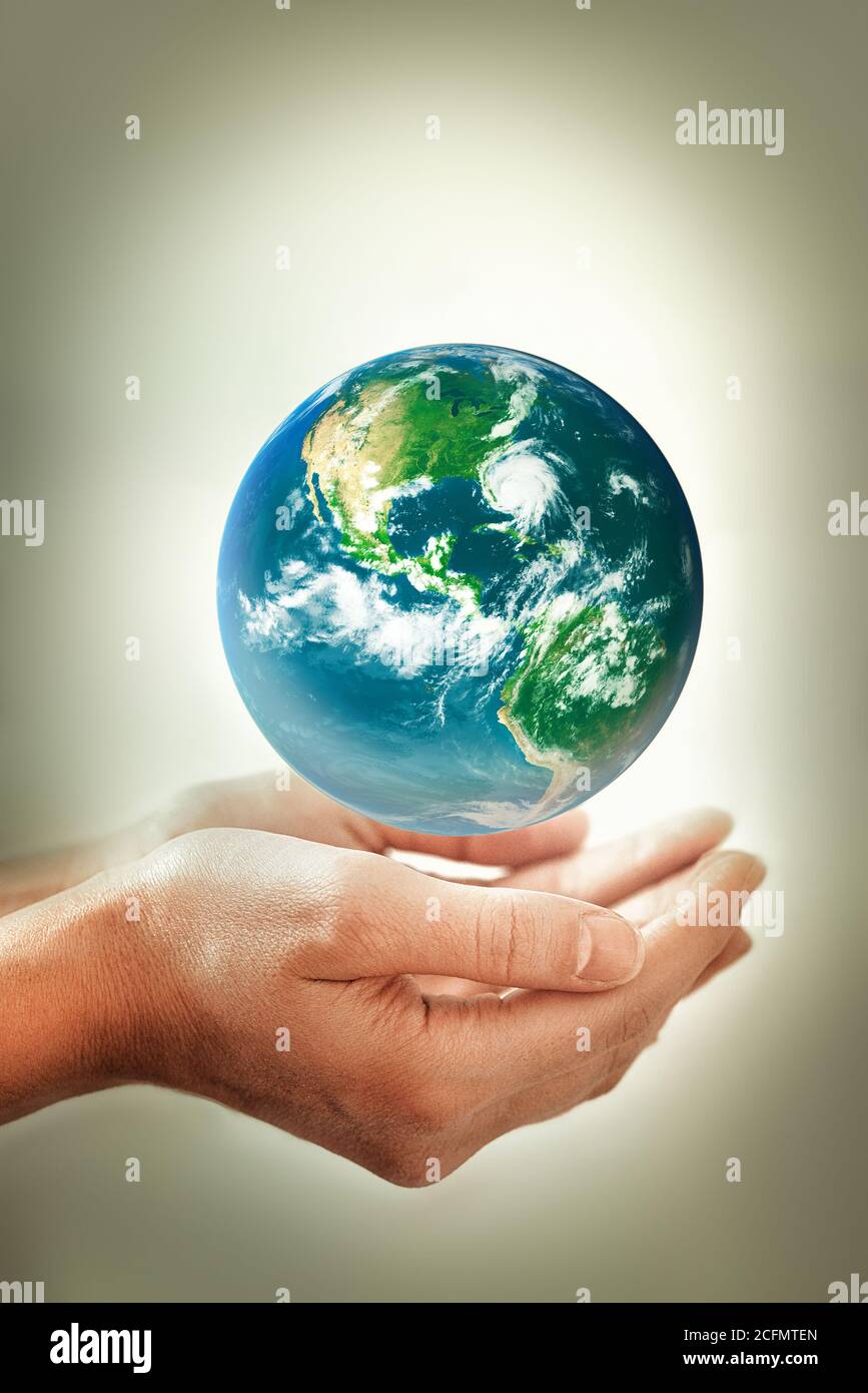Hands holding earth - conceptual image of the earth day, saving energy, protecting the environment. Elements of this image furnished by NASA Stock Photo