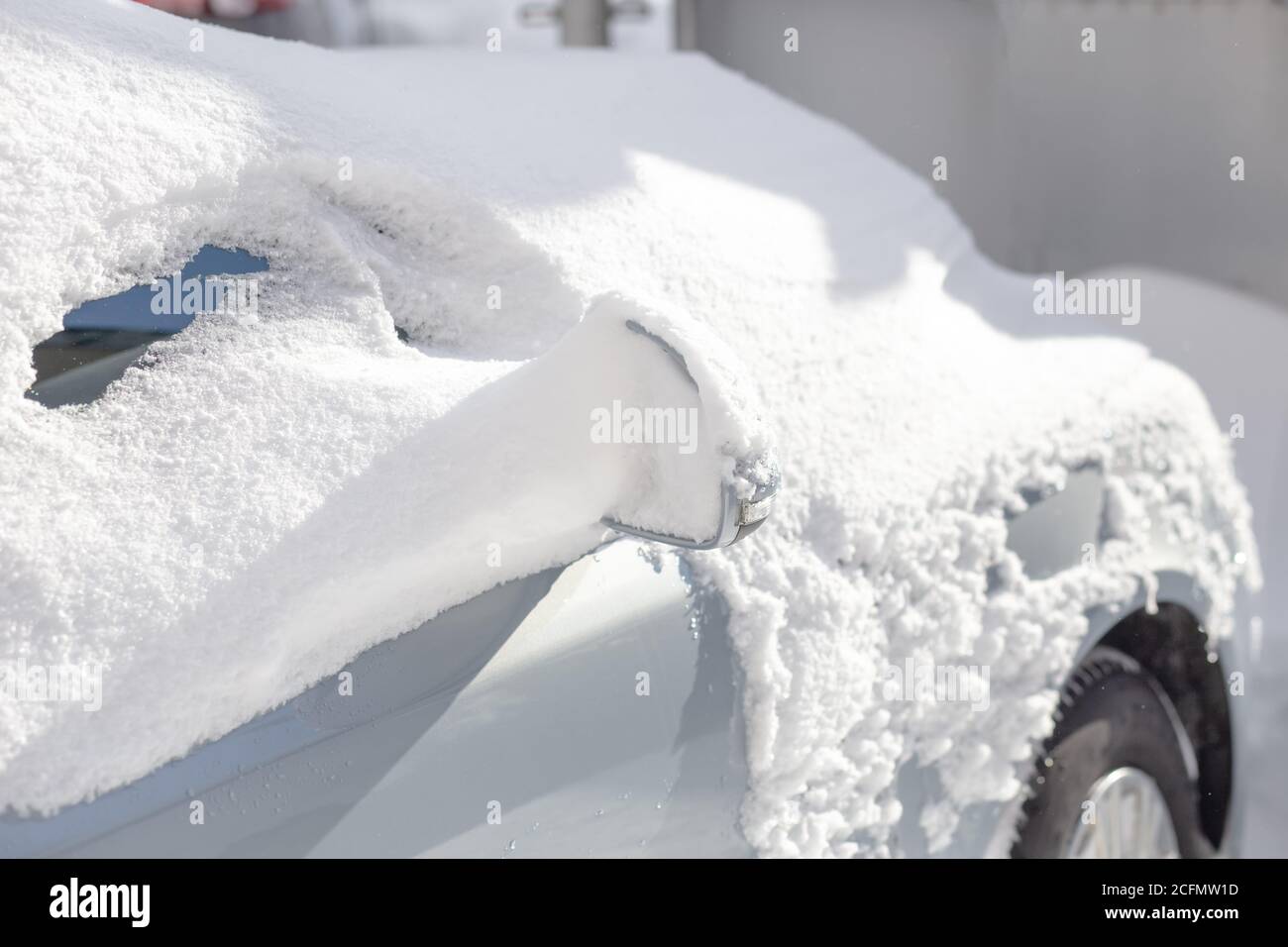 Car covered in snow. Winter concept, brushing snow of car Stock Photo Alamy