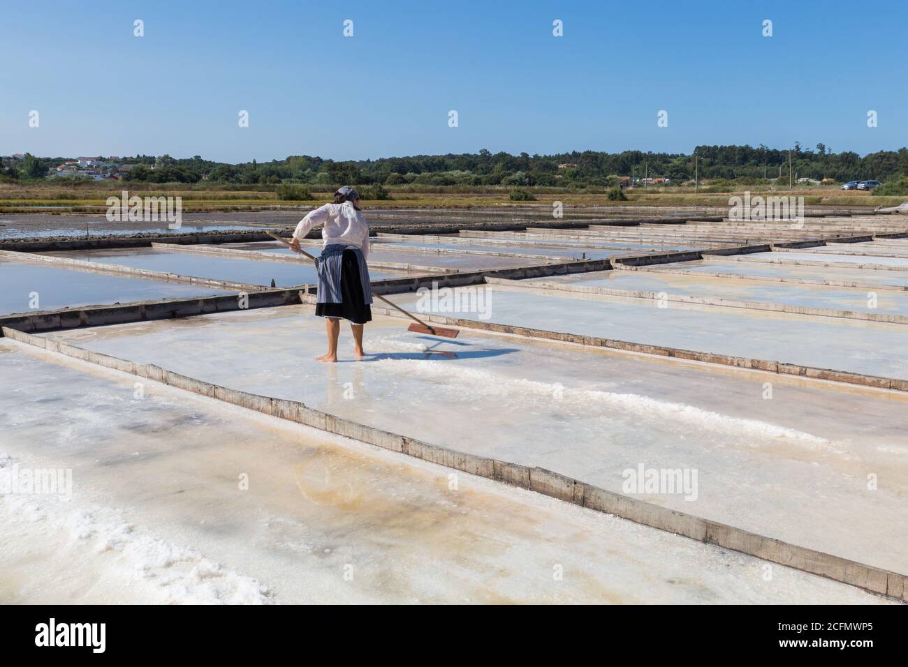 Woman working in traditional salt extraction in Figueira da Foz, Portugal Stock Photo