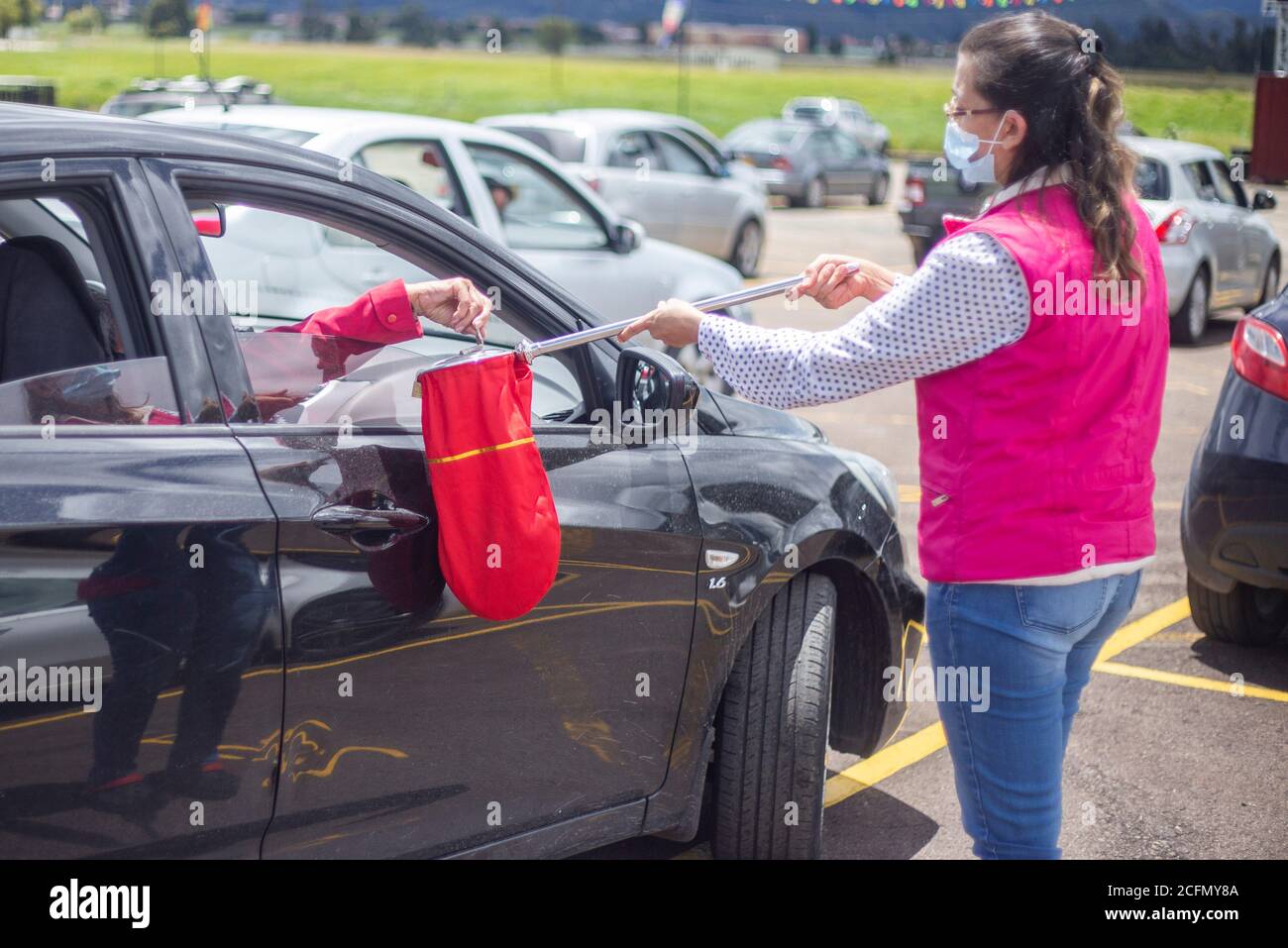 Bogota, Colombia. 6th Sep, 2020. One person passes by each car receiving donations in the car at the Los Andes racecourse in the city of BogotÃ¡.Due to the pandemic, the churches have not been able to reopen for people to go. In the coming weeks, the Colombian government will authorize the pilots for the opening. Credit: Daniel Garzon Herazo/ZUMA Wire/Alamy Live News Stock Photo