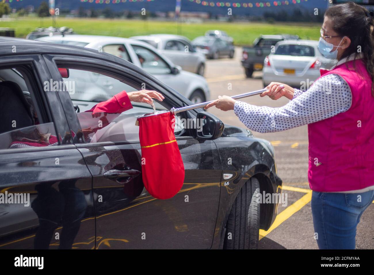 Bogota, Colombia. 6th Sep, 2020. One person passes by each car receiving donations in the car at the Los Andes racecourse in the city of BogotÃ¡.Due to the pandemic, the churches have not been able to reopen for people to go. In the coming weeks, the Colombian government will authorize the pilots for the opening. Credit: Daniel Garzon Herazo/ZUMA Wire/Alamy Live News Stock Photo
