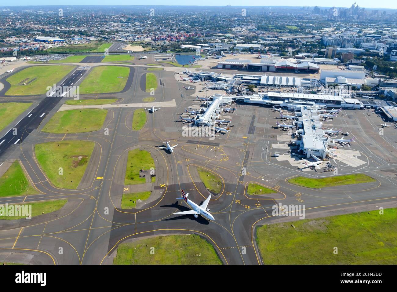 Sydney Airport runway, Domestic Terminal 2 and Terminal 3. Aerial view of terminal for domestic air travel in Australia. Multiple taxiway lines. Stock Photo