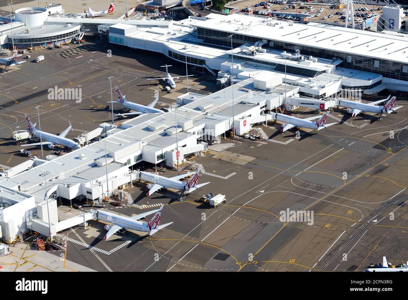 Virgin Australia domestic Terminal 2 at Sydney Airport, Australia. Passengers terminal with multiple 737 aircraft. Domestic air travel in Australia. Stock Photo