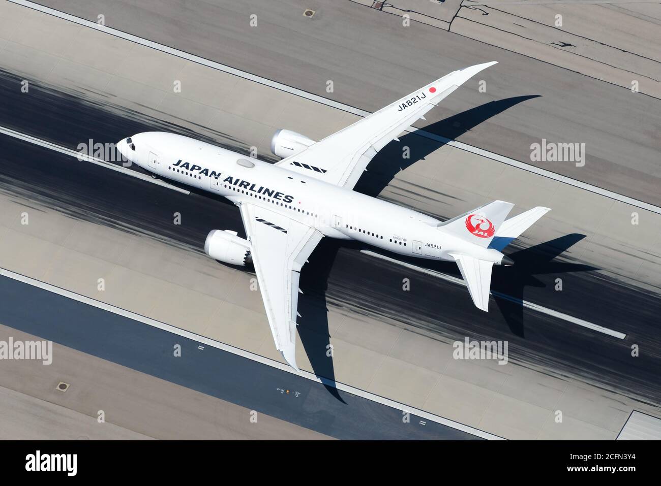 Japan Airlines Boeing 787 Dreamliner departing at an international airport runway. JAL Airlines aircraf. Stock Photo