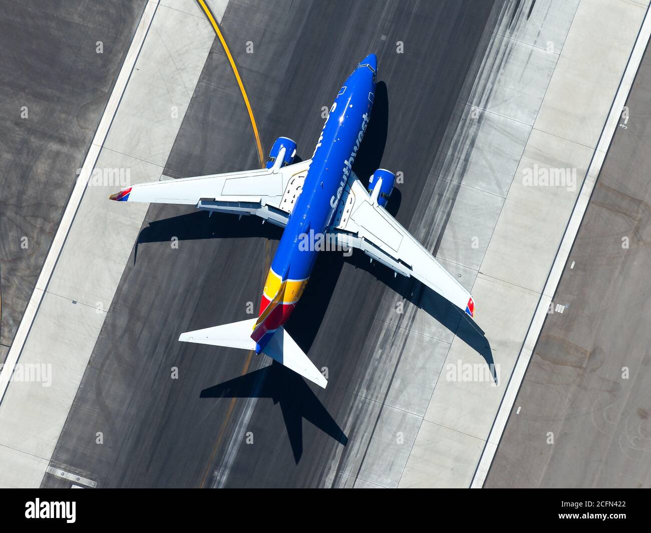 Southwest Airlines Boeing 737 arriving at Los Angeles Airport. Aerial view of airplnae over runway after landing. Wing flaps and slats visible. Stock Photo