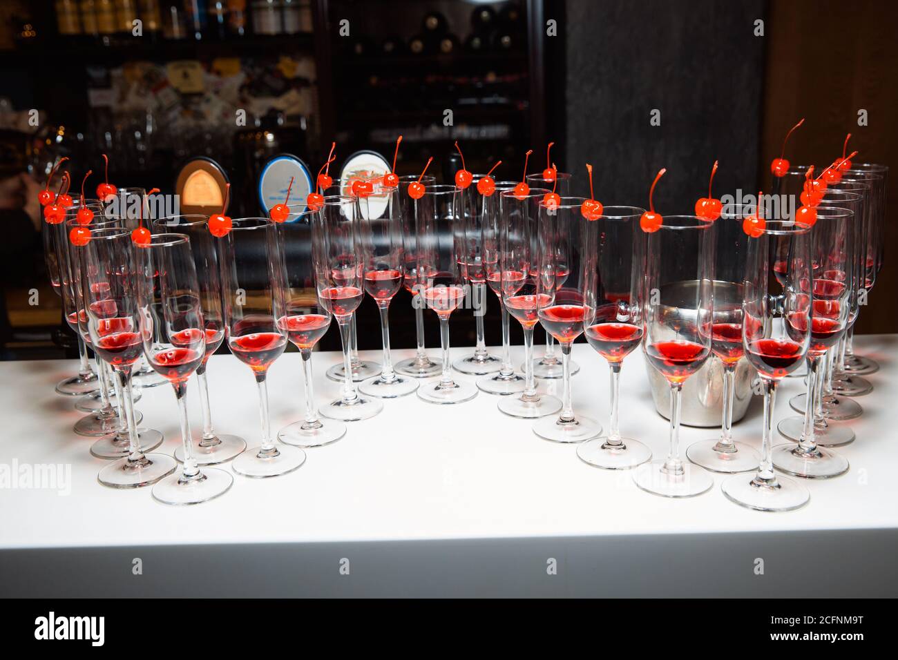 Empty wine glasses stand on a bar counter. On a glass of cherry for decoration. Stock Photo