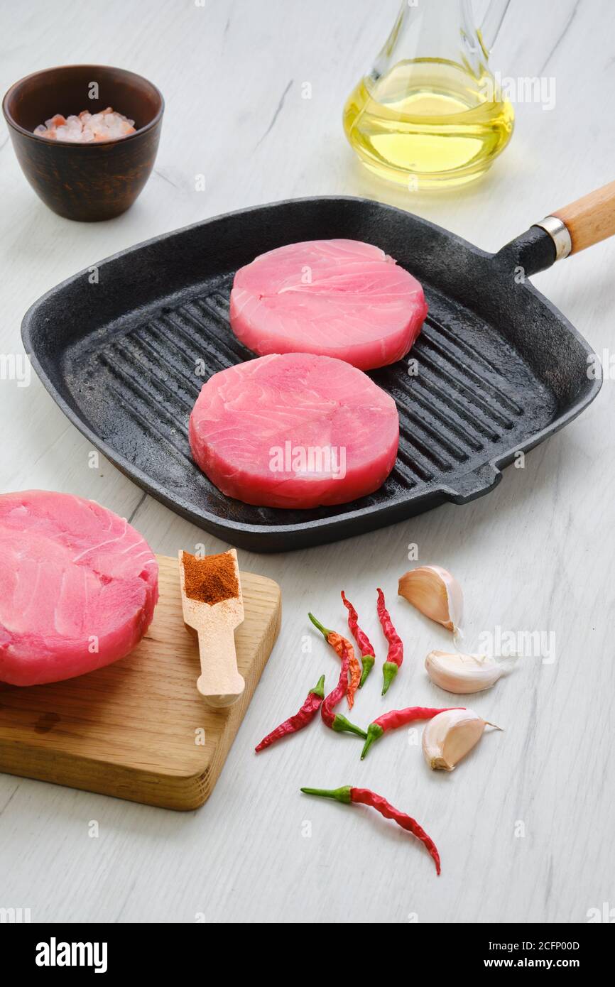 Frozen round tuna cutlet for burger or frying Stock Photo Alamy